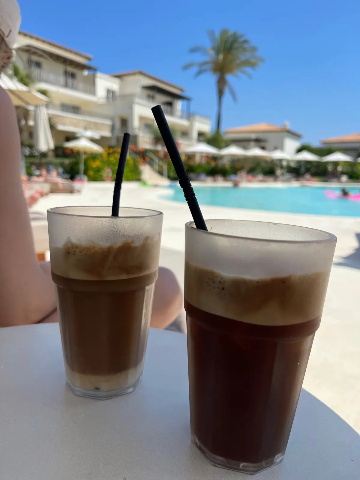 Two iced coffees by the pool