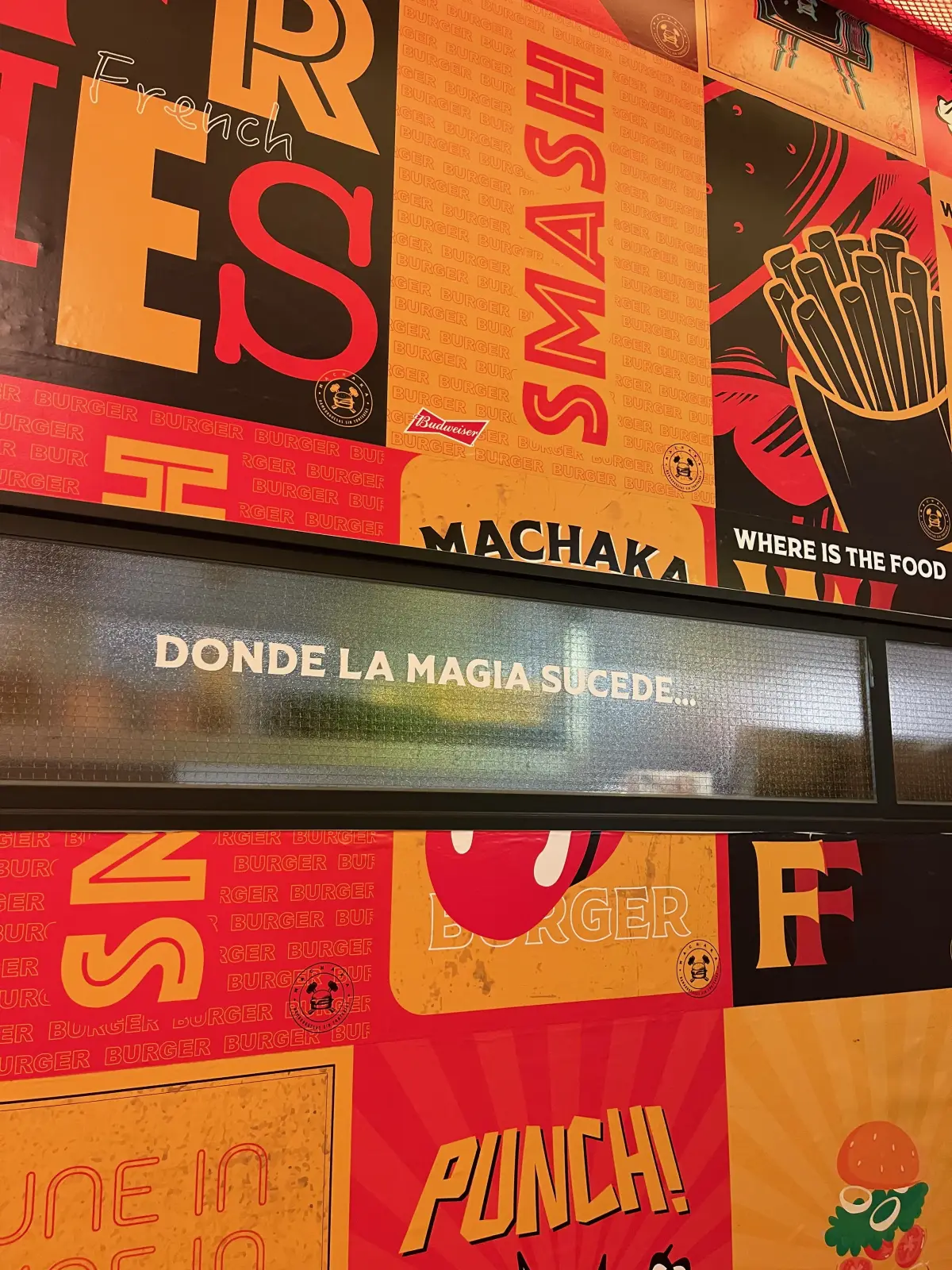 The wall slogan “donde la magia sucede” at Machaka