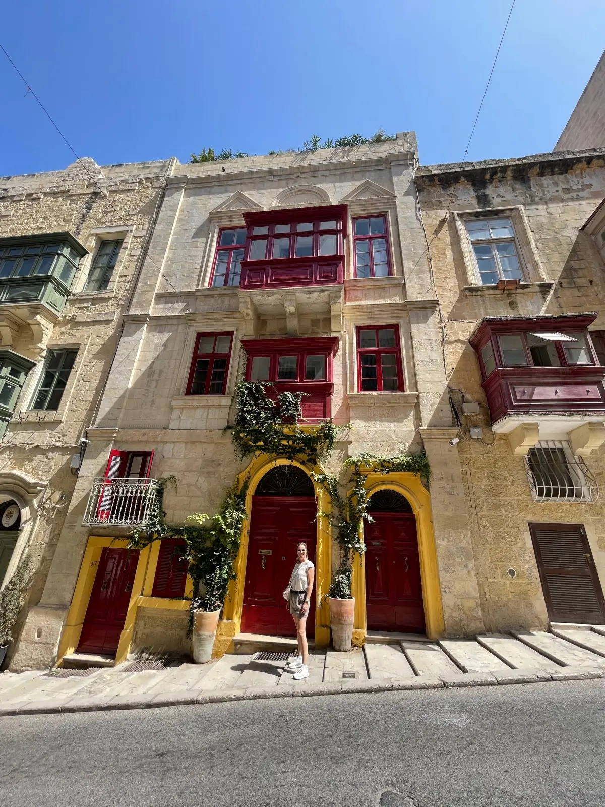 Red-painted balconies on a Valletta house