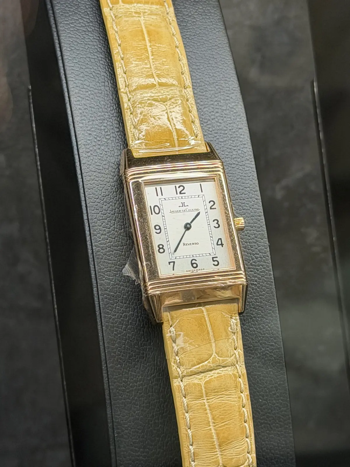 A rectangular watch on a yellow strap