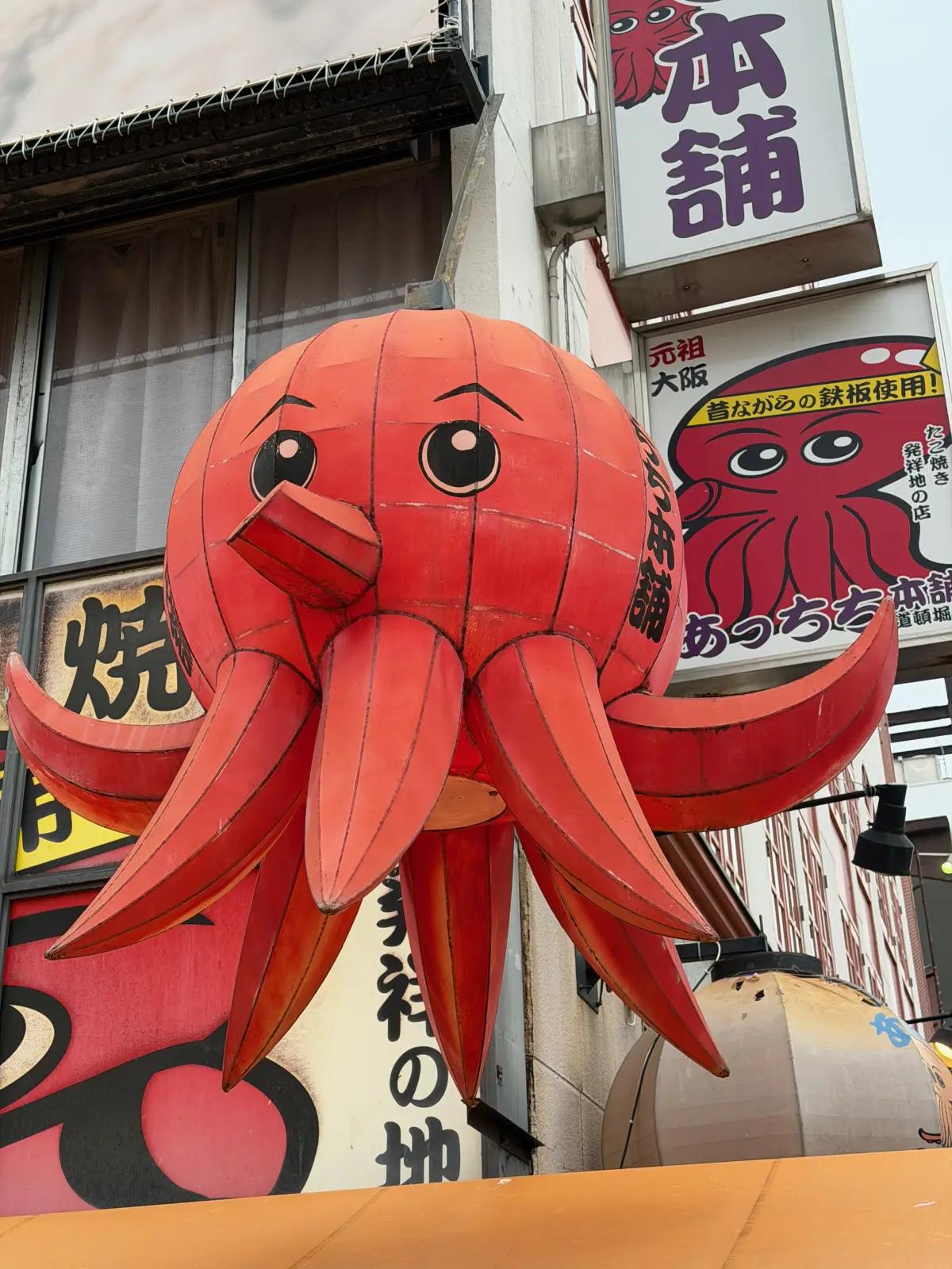 Giant octopus sign above a takoyaki stand in Dotonbori