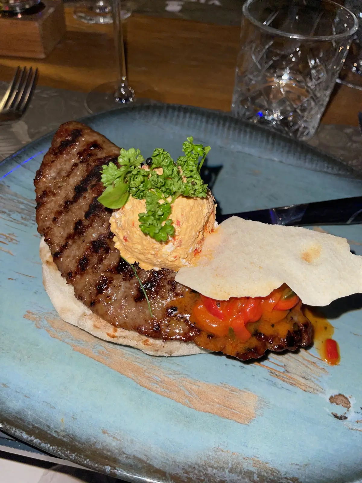Grilled meat with a creamy spread on flatbread at Visage Gastrobar
