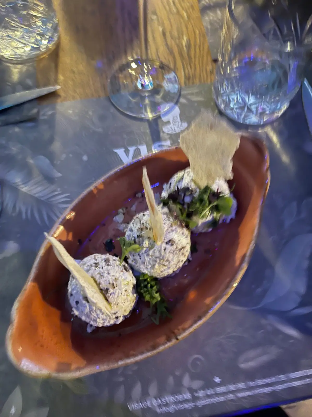 Sharing plate served in a boat-shaped bowl at Visage Gastrobar